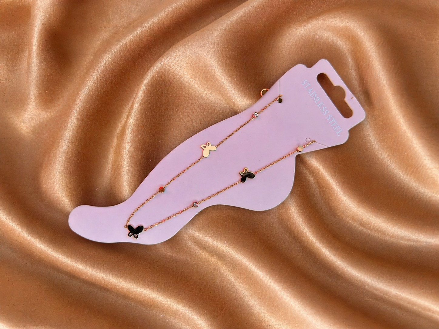 Butterfly Anklet on display card against brown silk cloth background